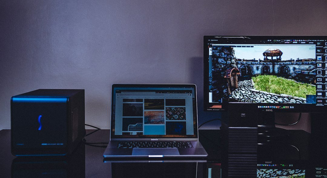 A laptop and separate desktop monitor on a work desk